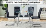 Table and chair set. (1 table+4 black chairs) Round dining table with a 40 inch diameter glass tabletop and silver plated metal legs. 4 black PU chair